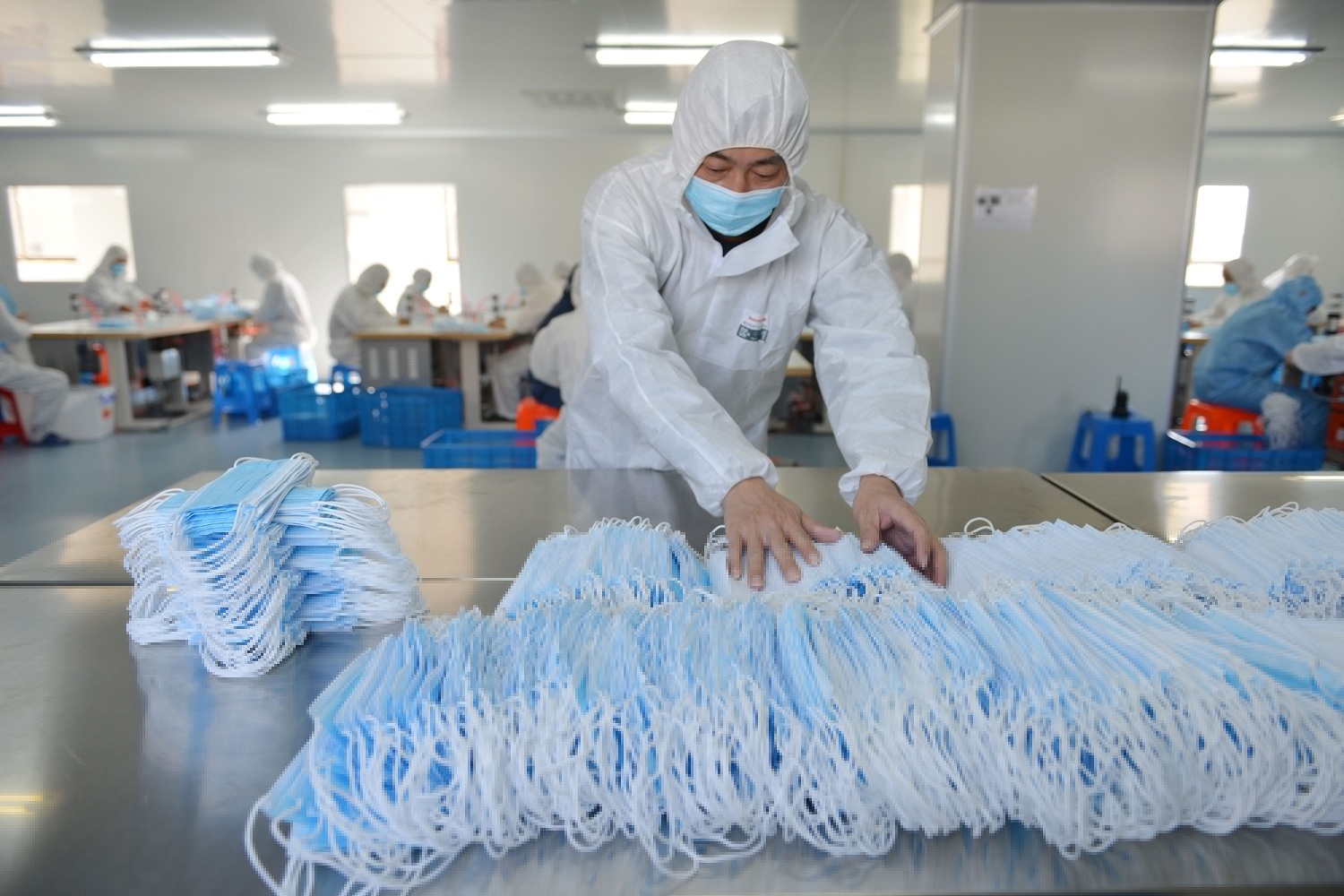 A worker at a factory in Nanjing sorting face masks being produced to satisfy increased demand