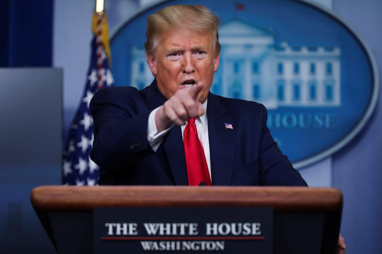 U.S. President Donald Trump points to a reporter as he answers questions during the daily coronavirus task force briefing at the White House in Washington
